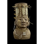 Ceramic sculpture of a male like figure, wiht a drum like hat on their head