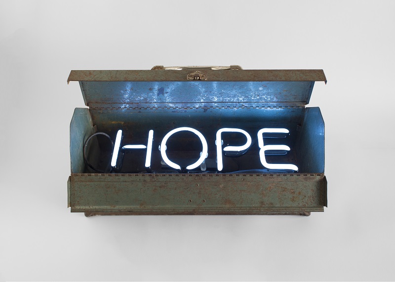 A toolbox with neon letters inside that read "HOPE".